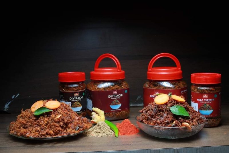 Jars of idiyirachi and meat cheenth beside plates of the food